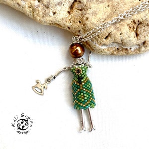 Green Beaded french Doll pendant with hobby-horse