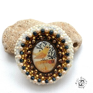 Bead embroidered picture brooch with little bird