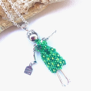 Green beaded French doll necklace with envelope