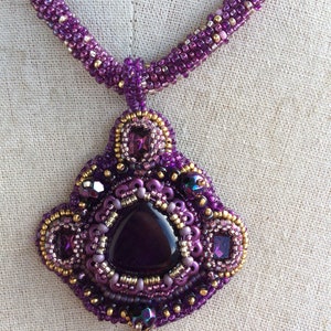 Pendentif brodé de perles violettes