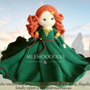 May include: A hand-knitted doll wearing a green dress with brown trim and a brown belt. The doll has red hair and a white face with black eyes. The doll is standing in front of a background of large stones.