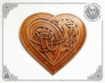 May include: A heart-shaped wooden carving with intricate Celtic knotwork patterns. The carving is made of light brown wood and has a smooth, polished finish.
