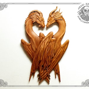 May include: A wooden carving of two dragons intertwined in a heart shape. The dragons are intricately detailed and have a warm brown color.