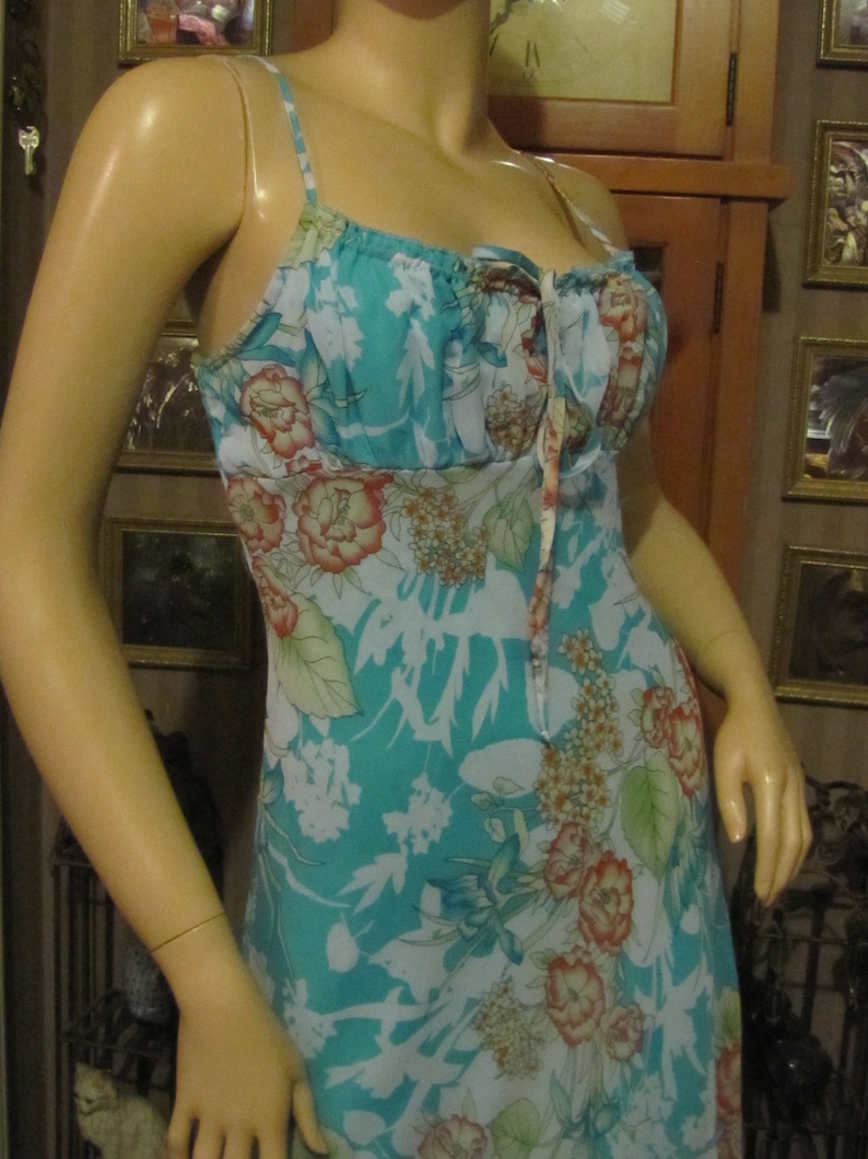 Darlin Aqua Floral Dress with Ruffled Hemline in size 78 Pretty B