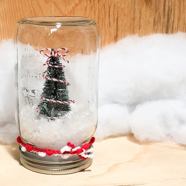 Candy Stripe Tree Dry Snowglobe, made with quart sized Mason Jar and snow fluff, red and white ribbons give traditional vibe