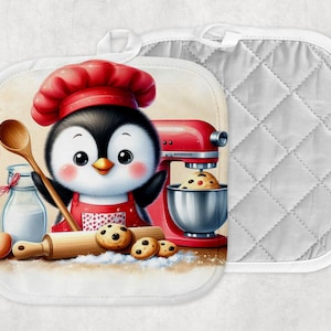 May include: A pair of white oven mitts. One mitt features a cartoon penguin chef wearing a red hat and apron, holding a wooden spoon. The penguin is surrounded by baking supplies, including a mixer, cookies, and a rolling pin. The other mitt is plain white with a quilted pattern.