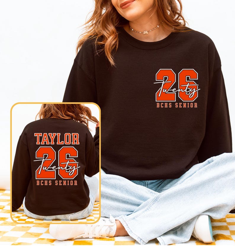 May include: Black sweatshirt with the number "26" and the word "Twenty" in a script font, with "BCHS SENIOR" below. The back of the sweatshirt has the name "TAYLOR", the number "26", the word "Twenty", and "BCHS SENIOR".
