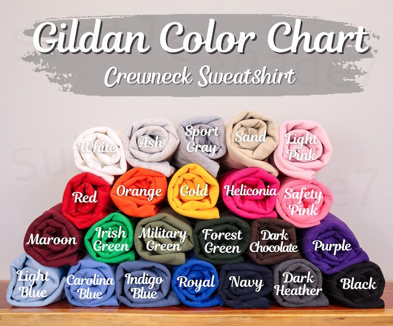 May include: A color chart for Gildan crewneck sweatshirts, displaying a variety of rolled-up fabric samples. Colors include white, ash, sport gray, sand, light pink, red, orange, gold, and more. The text "Gildan Color Chart" is at the top.