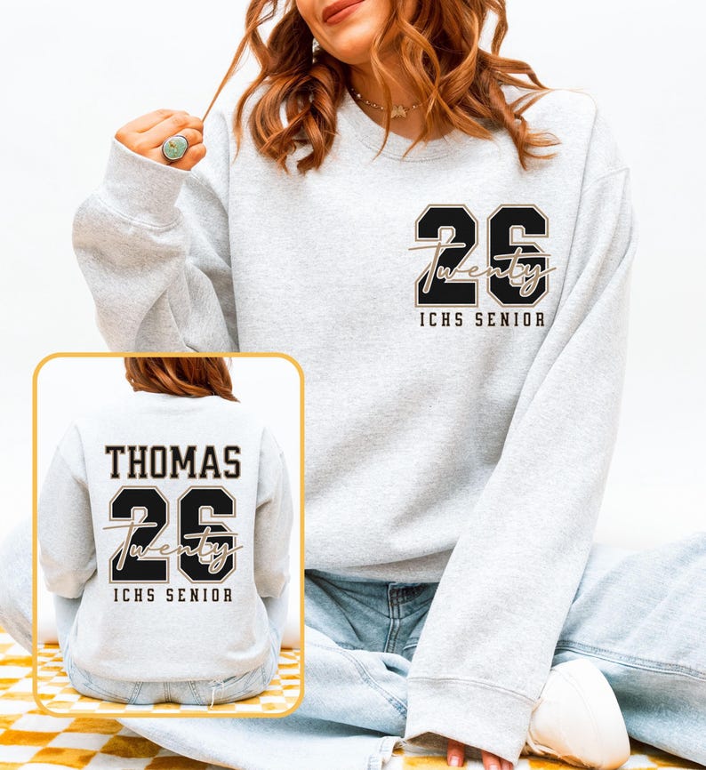 May include: Light gray sweatshirt with the number "26" and the word "Twenty" in a script font. The text "ICHS SENIOR" is below. The back of the sweatshirt has the name "THOMAS" above the number "26" and the word "Twenty" and "ICHS SENIOR".