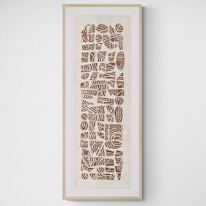 Peut inclure: Une impression d'art abstrait encadrée avec un motif géométrique brun et blanc. L'impression est dans un cadre en bois clair et est accrochée à un mur blanc.