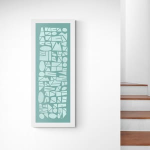 May include: A framed print featuring a geometric pattern of white shapes on a light blue background.