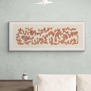 May include: Abstract art print in a light wood frame. The artwork features a series of interconnected, organic shapes in shades of red, orange, and gold against a cream background. The framed art is displayed on a light blue wall.