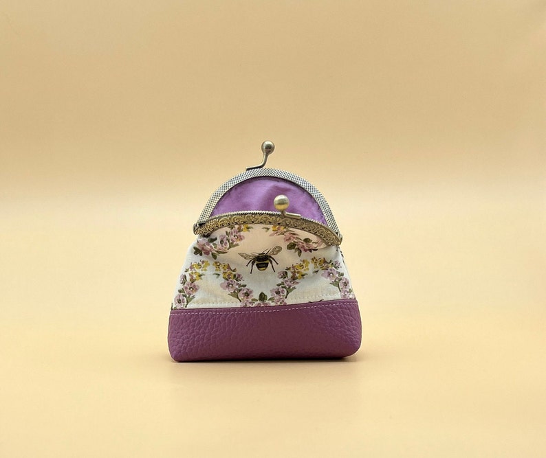 Coin purse kiss clasp purple inside.