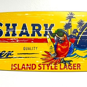 Land shark parrot surfboard, 46.5" x 9.3" x 1/4" shark-bite design. Aluminum Alpha Panel material made for indoor and outdoor use.