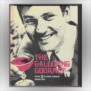 May include: A book cover featuring a man holding a glass of red wine. The book title is "The Galloping Gourmet" with the subtitle "Volume 3 Television Cookbook" by Graham Kerr.