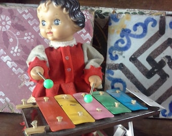 Vintage doll plays xylophone