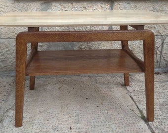 May include: A light wood end table with a lower shelf. The table has a rectangular top and four legs.