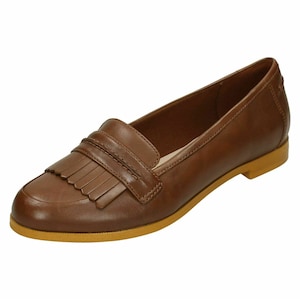 May include: Brown leather loafers with a fringe detail and a light brown sole.