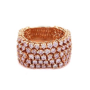 May include: A gold ring with a wide band set with multiple rows of small, round, clear diamonds.
