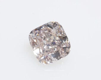 May include: A light pink cushion-cut diamond gemstone.