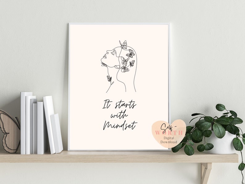 May include: A black and white line drawing of a woman's face with butterflies around her head. The text "It starts with Mindset" is below the drawing. The image is on a white background.
