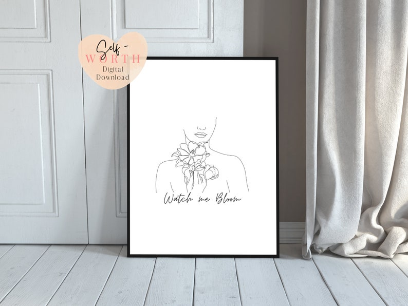 May include: Black and white line art print of a woman with flowers around her neck. The text "Watch me Bloom" is below the image.