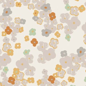 May include: A white fabric with a repeating pattern of small, stylized flowers in shades of gray, orange, and yellow. The fabric is measured with a ruler in inches.