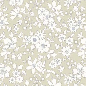 May include: A seamless pattern featuring white floral designs on a light beige background. The pattern includes various flower shapes and sizes, creating a delicate and intricate design.
