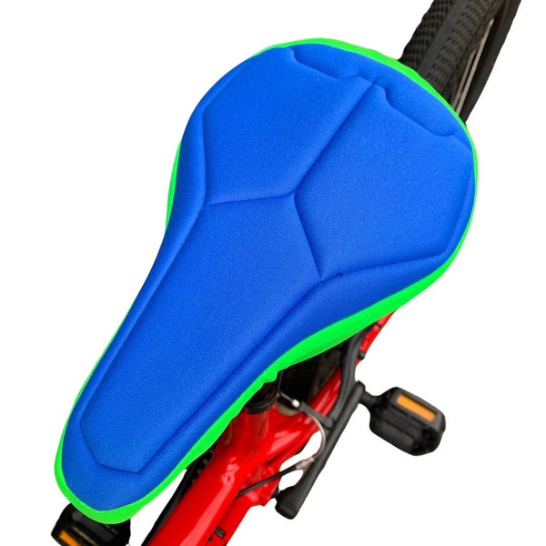 Housse de selle de vélo rembourrée bleue et verte pour enfants en textile respectueux de l'environnement. Mousse de haute technologie pour un soutien maximal et une base résistante à l'eau