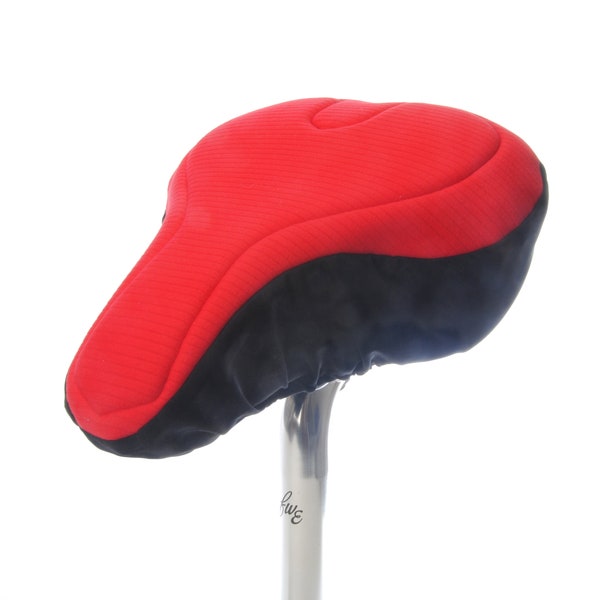 Housse de selle de vélo rouge rembourrée en textile respectueux de l'environnement. Propriétés de la mousse de haute technologie pour un soutien et un confort maximum. Coupe anatomique pour FEMME