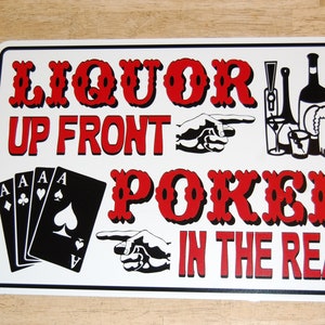 May include: White metal sign with red text that reads "Liquor Up Front Poker In The Rear". The sign also features a hand pointing to the left with four aces and a bottle of wine, a glass of liquor, a martini glass, and a beer mug.