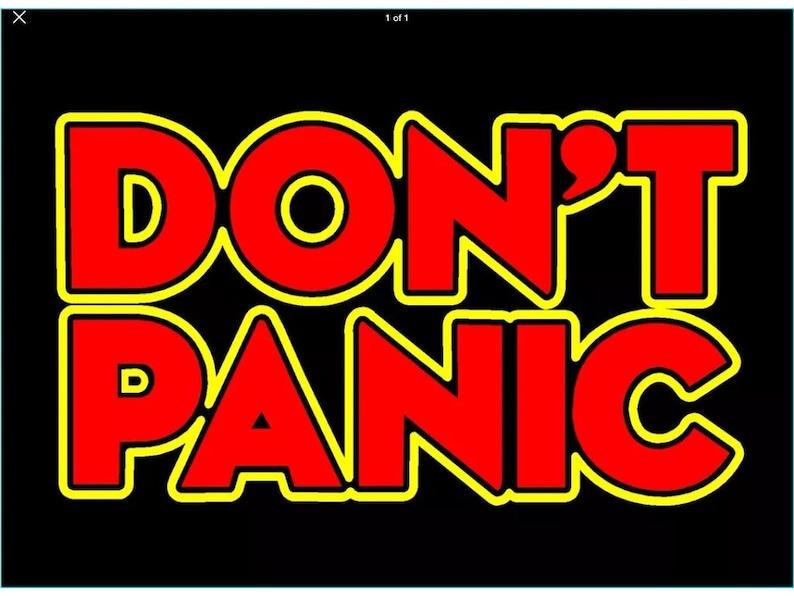 May include: A black background with the words "DON'T PANIC" in red letters with a yellow outline.