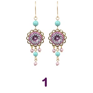 May include: A pair of dangle earrings with a pink and silver beaded flower charm, turquoise beads, and gold-tone hooks.