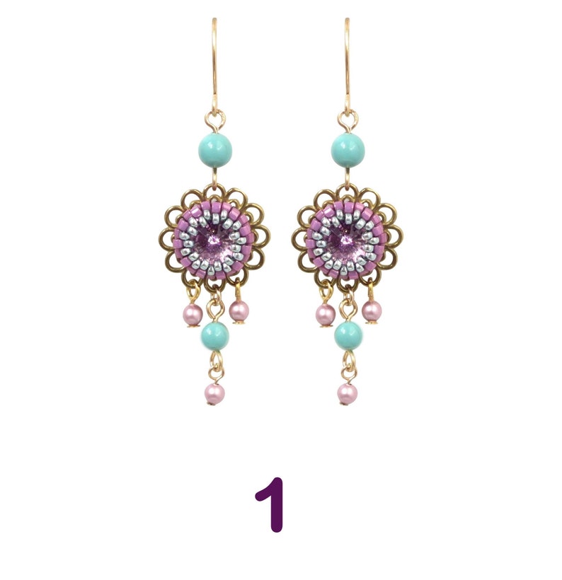 May include: A pair of dangle earrings with a pink and silver beaded flower charm, turquoise beads, and gold-tone hooks.