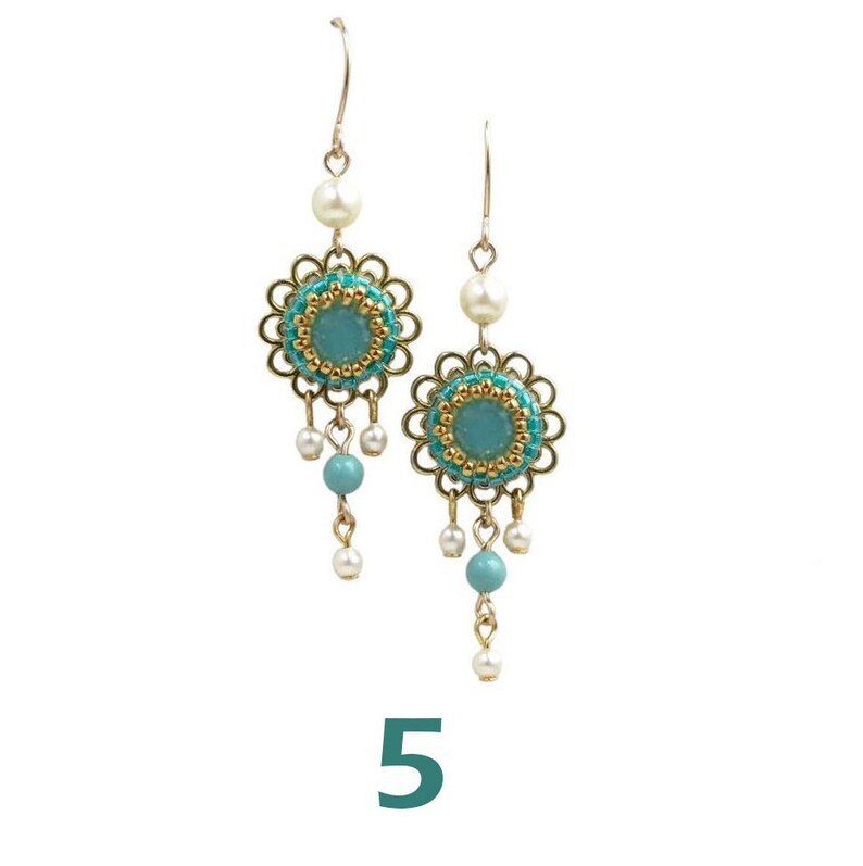 May include: A pair of gold dangle earrings with turquoise and white beads. The earrings feature a round turquoise stone surrounded by gold beads and a floral design.