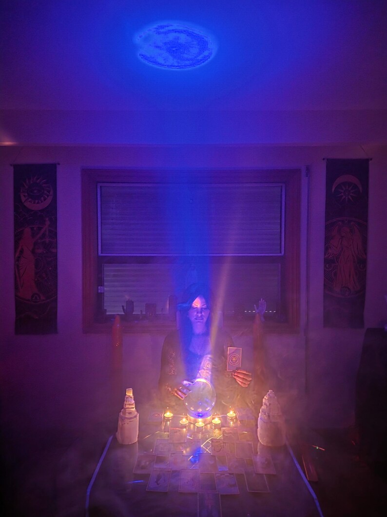 psychic amanda looking deeply at tarot and crystal ball