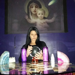 psychic Amanda performing a empathic reading surrounded by candles and crystals