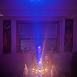 psychic amanda looking deeply at tarot and crystal ball