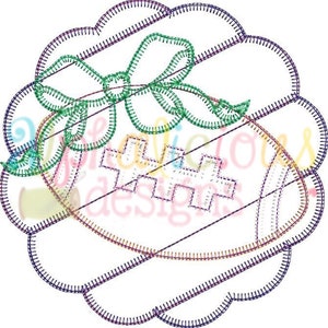 May include: A colourful embroidered design of a football with a green bow on top. The design is in a circular shape with a scalloped edge.