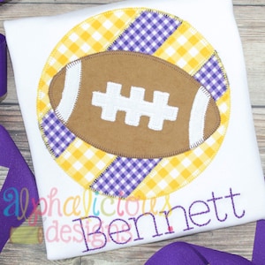 May include: A white t-shirt with a yellow and purple gingham circle with a brown football in the centre. The text "Bennett" is embroidered below the circle.