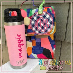 May include: A pink Yeti water bottle with the name "Maggie" written in pink on the side. A blue and white checkered fabric circle with a pink monogram "M.B.C." is attached to a colorful bag with a green and white patterned strap.
