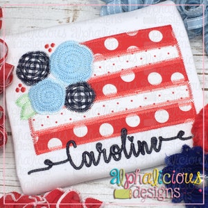 May include: Embroidered design featuring a red, white, and blue American flag with a floral embellishment and the name "Caroline" stitched below.