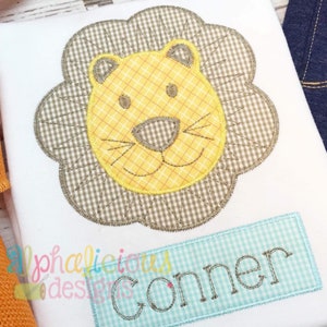 May include: A brown and yellow lion face with a stitched design on a white t-shirt. The name "Gonner" is stitched on a blue and white checkered rectangle below the lion.