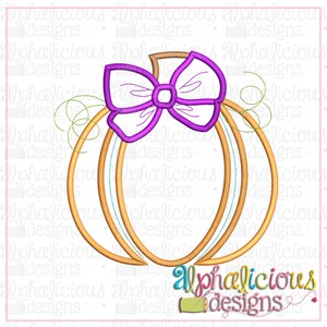 May include: A gold pumpkin with a purple bow on top. The pumpkin is outlined in a darker gold colour. The bow has a white centre and is decorated with a swirl pattern.