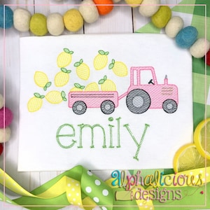 May include: A pink tractor with a wagon full of lemons. The tractor is pulling a wagon full of lemons. The word "emily" is embroidered below the tractor.