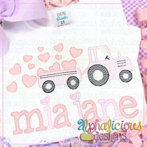 May include: A pink tractor pulling a wagon full of pink hearts with the name "mia jane" embroidered in pink on a white shirt.
