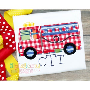 May include: Red and white gingham fire truck applique with blue details and a yellow star on top. The truck has a hose and a ladder. The name "CTT" is embroidered below the truck.