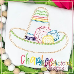 Pode incluir: Desenho bordado de um sombrero colorido com flores em uma camisa branca. O texto "Chapalicious Designs" está bordado abaixo do sombrero.