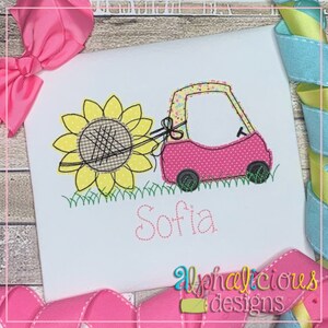 May include: Embroidered design of a pink car pulling a yellow sunflower with the name Sofia stitched below.