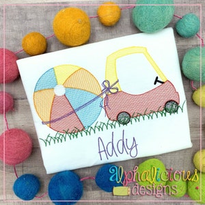 May include: Embroidered design of a red toy car pulling a beach ball with the name "Addy" underneath. The design is on a white t-shirt.